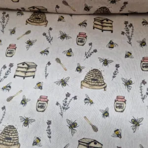 Stof met bijenprint op panama katoen met bijenkorven honingpotjes en bijtjes Bestel in de stoffenwebwinkel Makomastoffen Deventer
